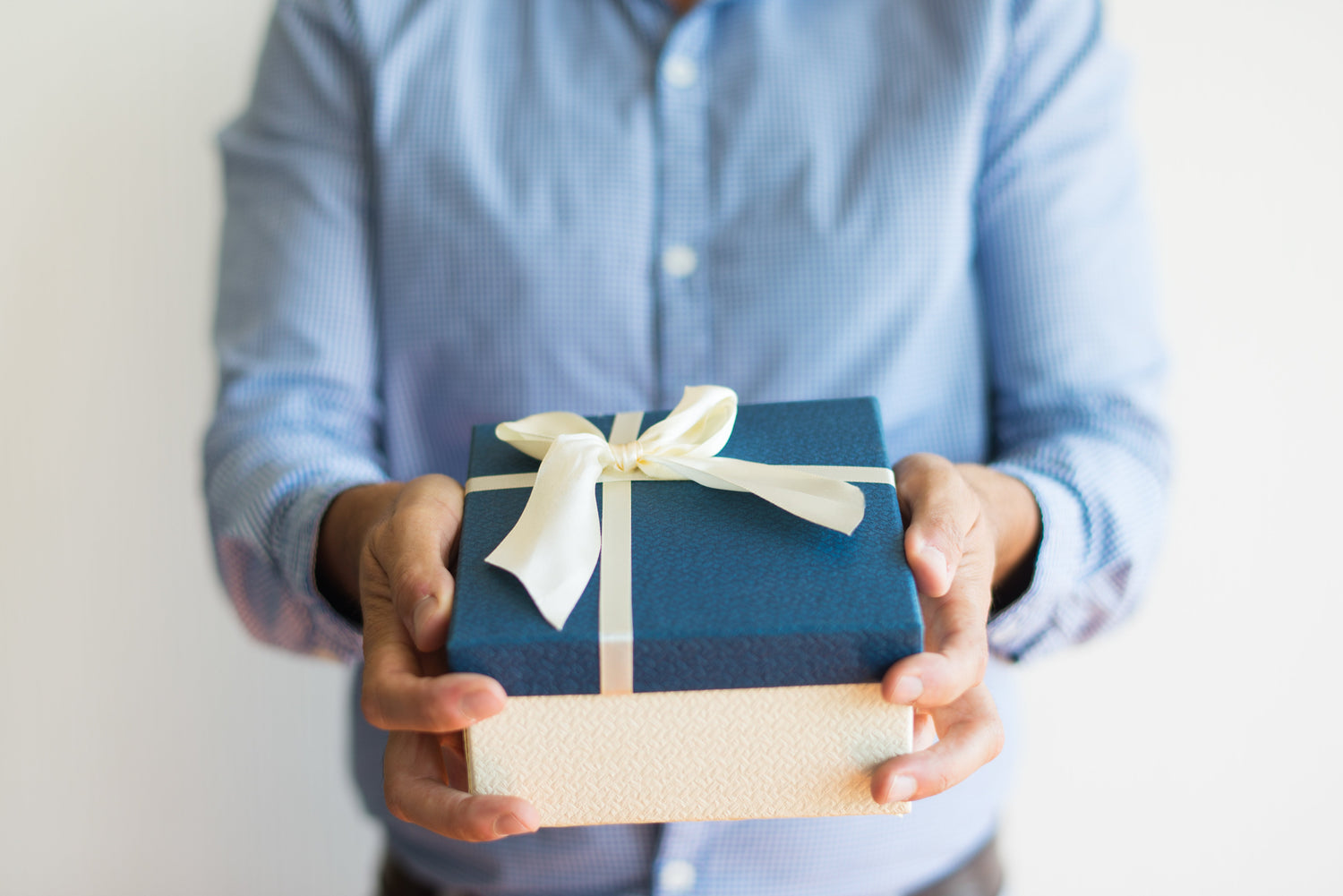 Close up of man holding a gift box