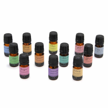 Collection of small essential oil bottles with colorful labels on a white background